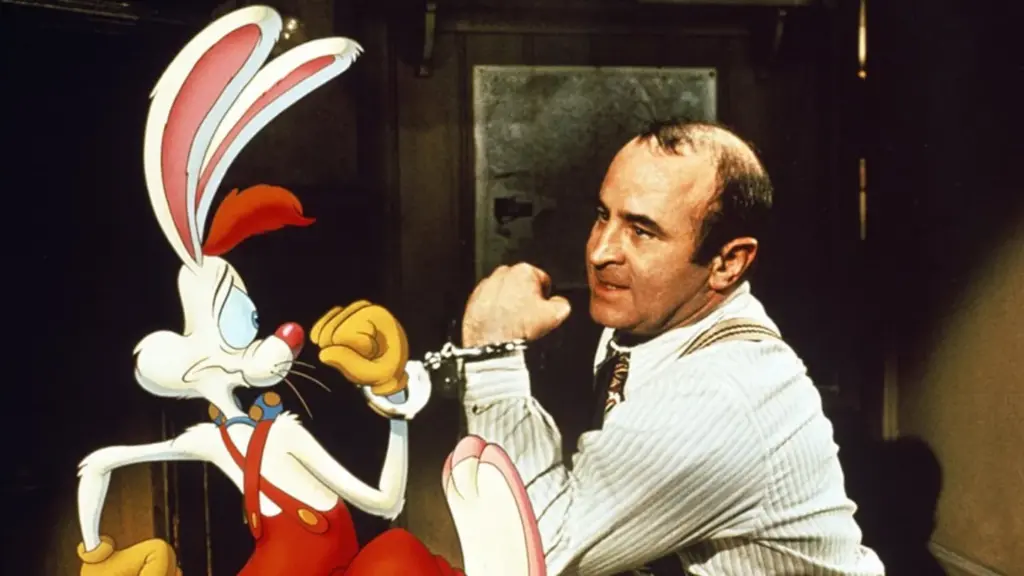 A still from the film Who Framed Roger Rabbit, depicting the cartoon character Roger Rabbit handcuffed to the private investigator Eddie Valiant, played by actor Bob Hoskins.
