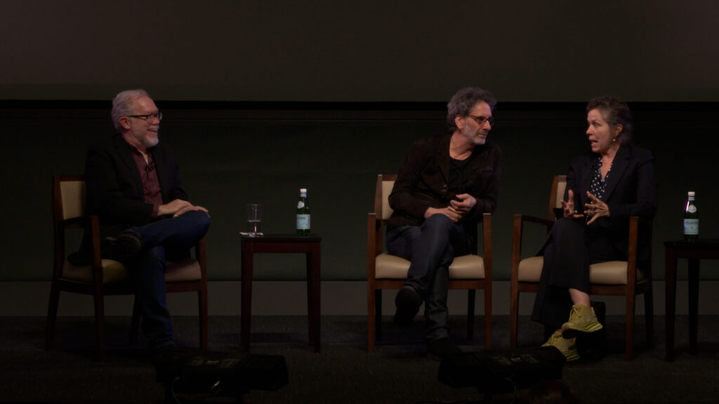 Moderator Jim Kearney with guests Joel Coen and Frances McDormand on stage at the Pollock Theater during a Q&A.