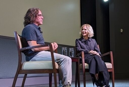 Director Brad Silberling and actor Meg Ryan are seated in two chairs and are engaged in conversation onstage at the Pollock Theater.